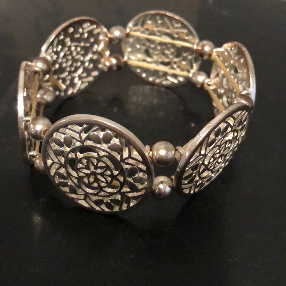 Francesca’s silver tone filigree disc bracelet.